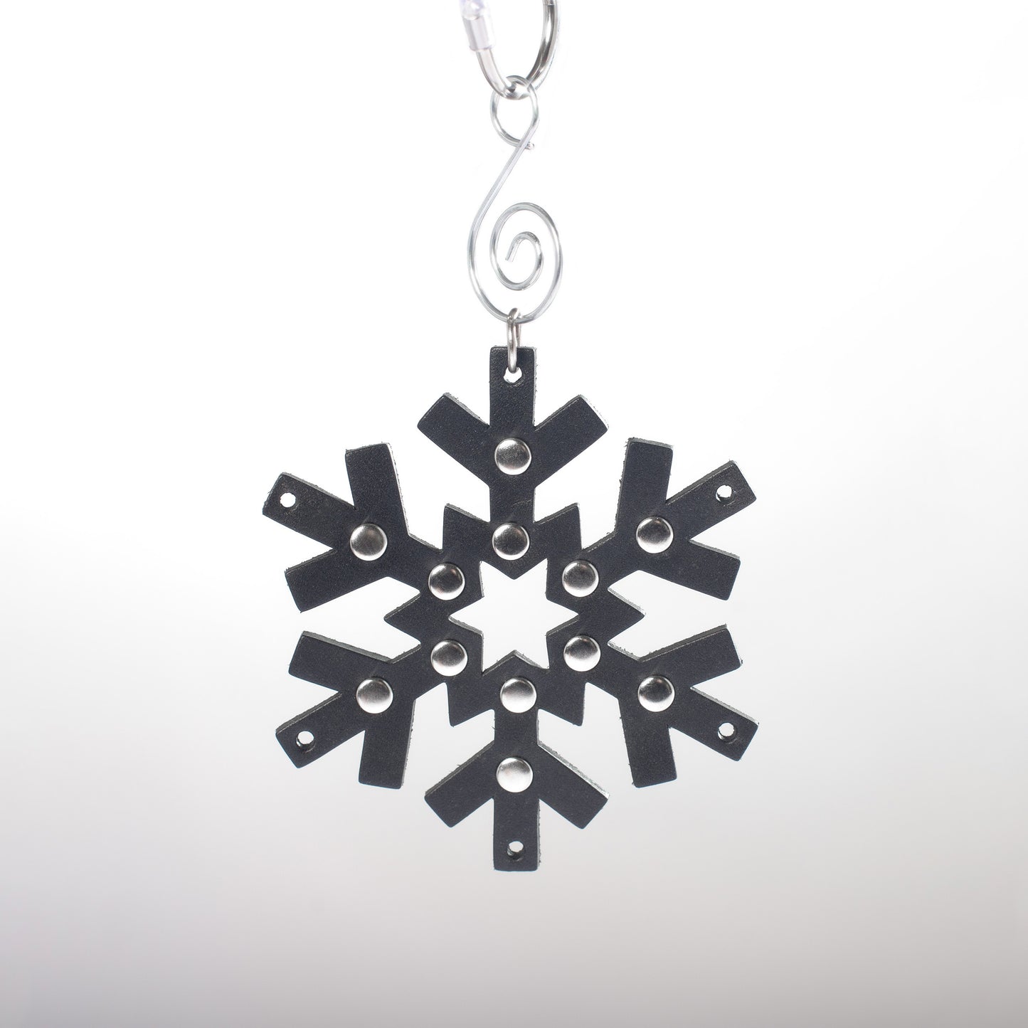 Gothic black leather snowflake shaped ornament with silver studded details.