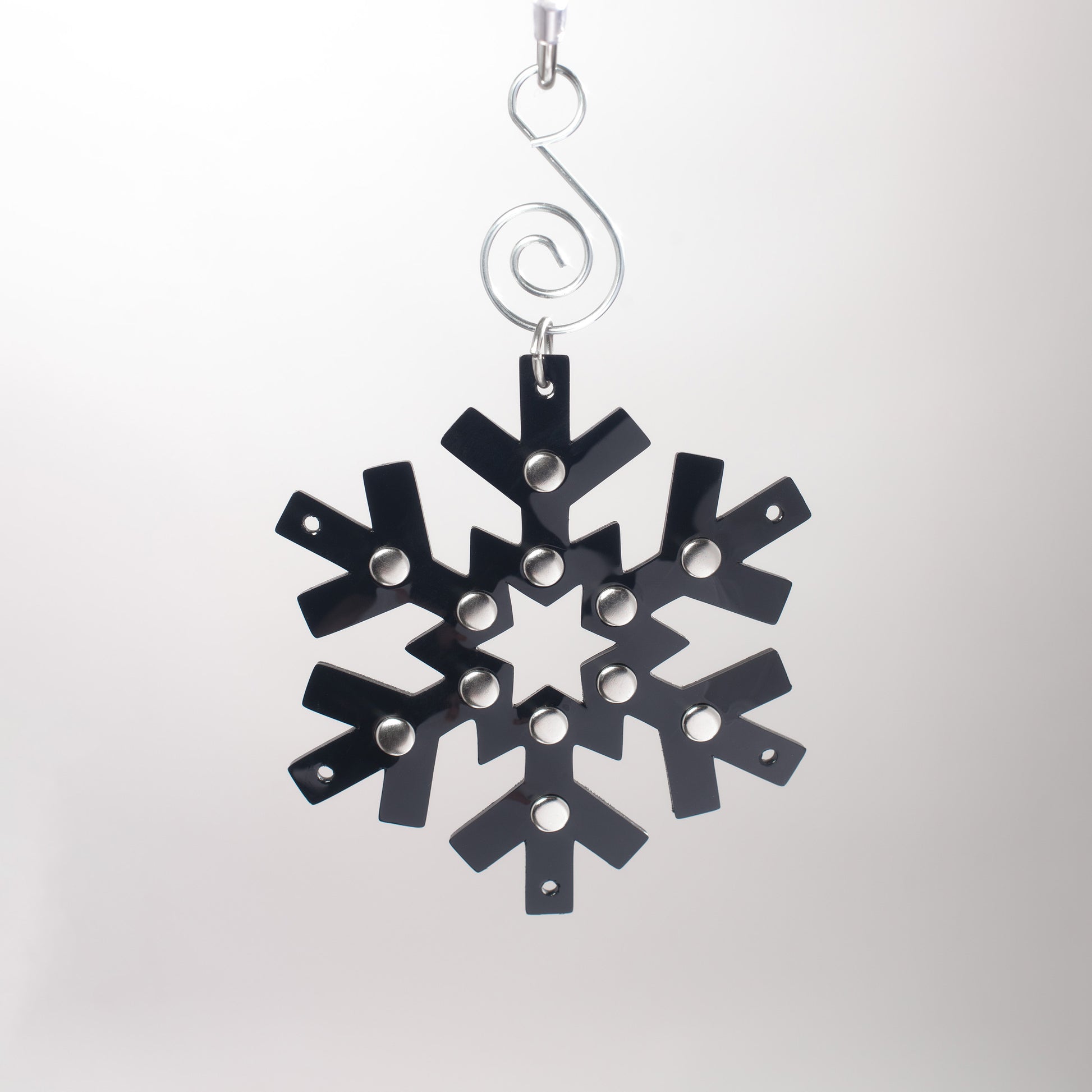 Gothic black pvc snowflake shaped ornament with silver studded details.