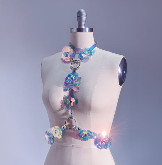 Rainbow, iridescent, holographic roses fashion  harness. Ornate, sculptural, three-dimentional floral harness displayed on a professional dressform.