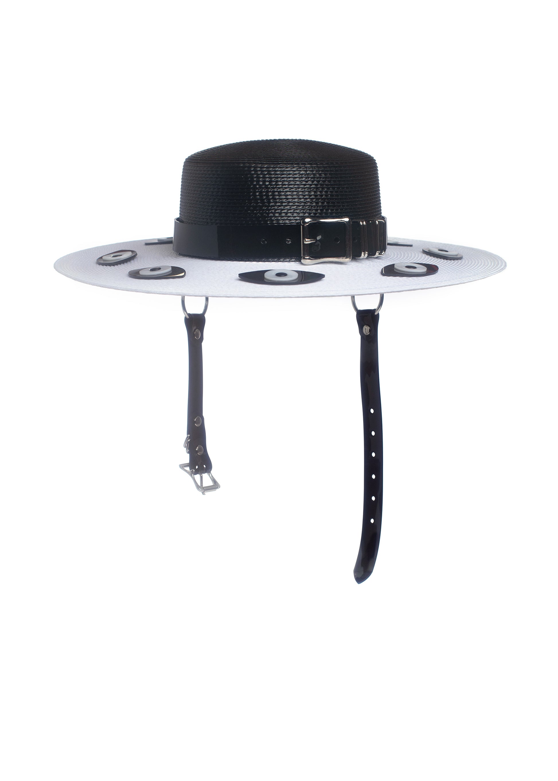 Apatico harness hat with wide brim. Black and white two-tone faux strap. Eyeball design all around the brim.