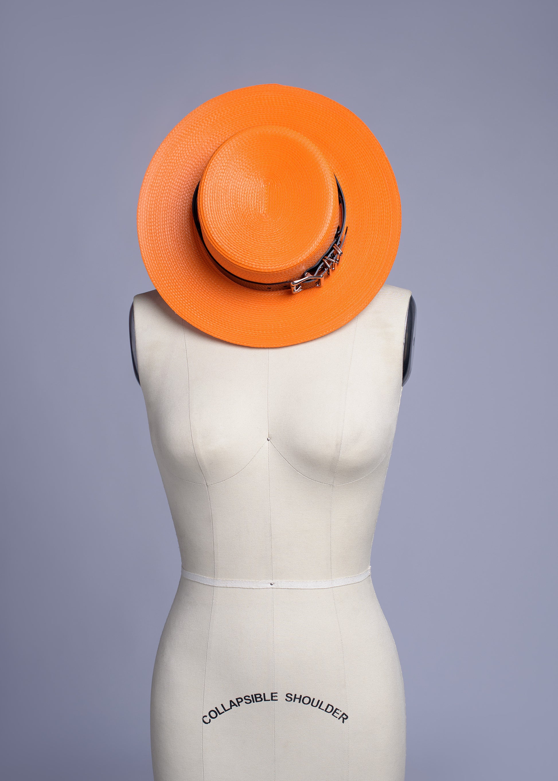 Apatico harness hat in orange with black pvc buckle band and harness chin straps, perfect spooky halloween vibes