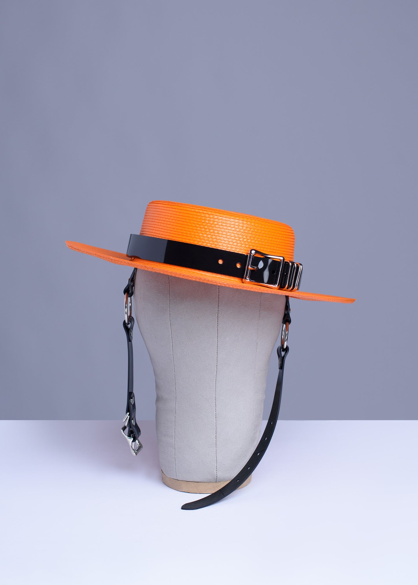 Apatico harness hat in orange with black pvc buckle band and harness chin straps, perfect spooky halloween vibes