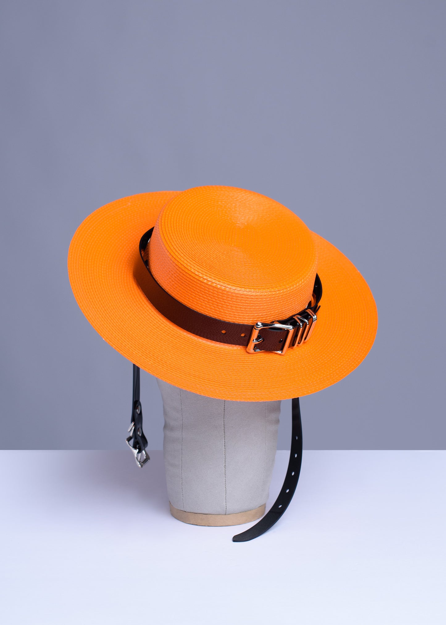 Apatico harness hat in orange with black pvc buckle band and harness chin straps, perfect spooky halloween vibes