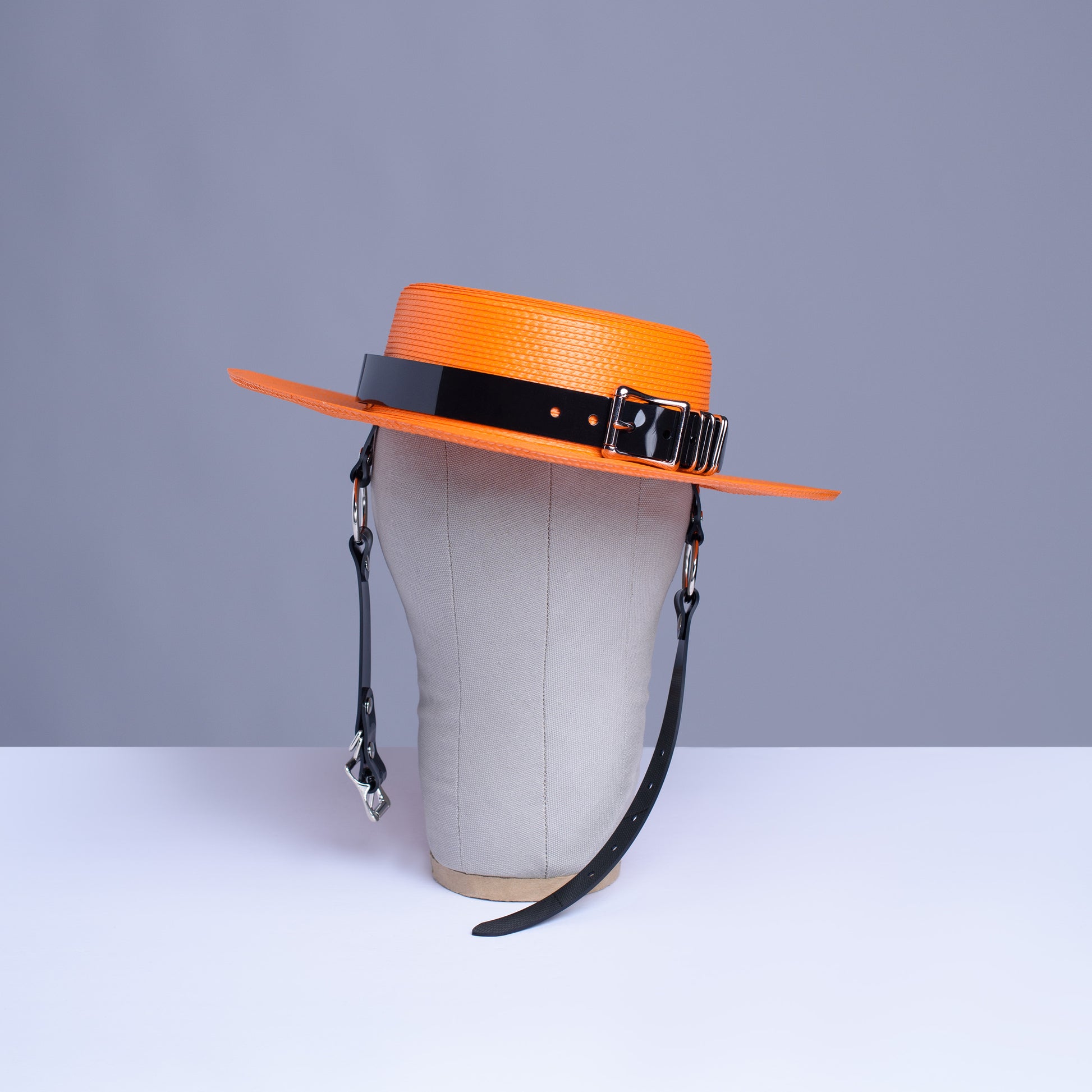 Apatico harness hat in orange with black pvc buckle band and harness chin straps, perfect spooky halloween vibes